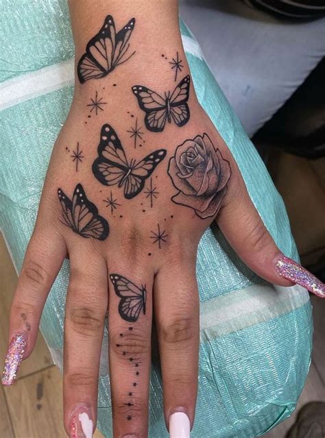 30 Cute Butterfly Tattoos Butterflies On The Hand With A Rose