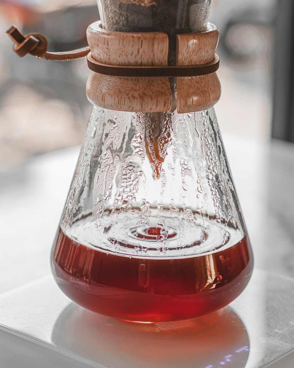 A Beakle Filled With Liquid Sitting On Top Of A Table