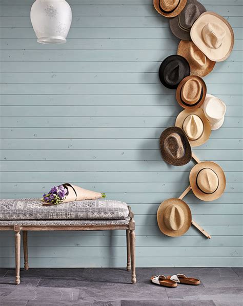 A Hat And Purse Are Hanging On A Wall With Shelves Above It That Hold Hats