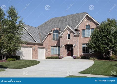 A Large Brick House With Three Garages