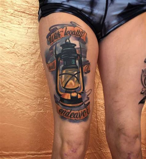 A Tattoo With An Image Of A Lantern On It S Leg That Says All That Was