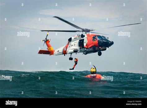 A Us Coast Guard Rescue Swimmers Are Deployed From A Mh 60 Jayhawk