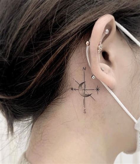 A Woman S Behind The Ear Has A Compass Tattoo On Her Left Side