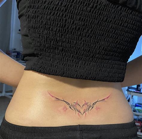 A Woman S Lower Back Tattoo With Two Birds On It And The Bottom Part