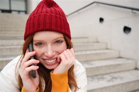 A Woman With A Ring On Her Left Hand Is Talking On The Phone And Has