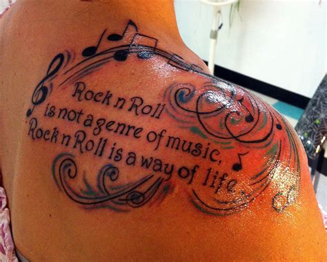 A Woman With A Tattoo On Her Back Saying Rock N Roll Is Not A Gesture