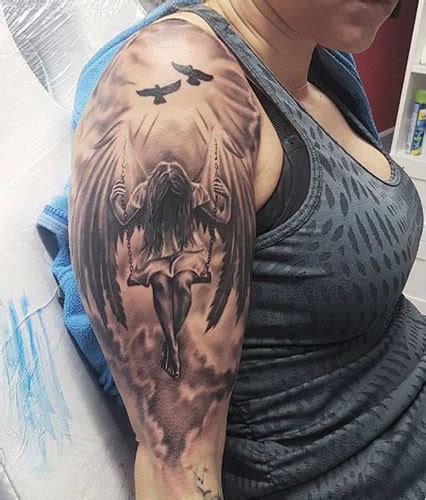 A Woman With An Angel Tattoo On Her Shoulder