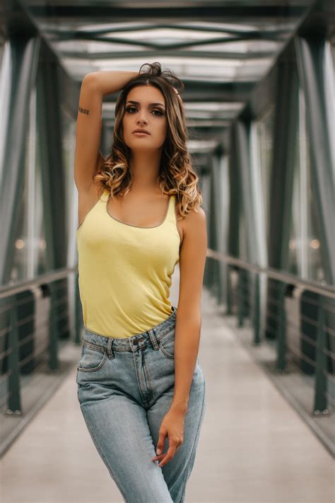 A Woman With Pink Lipstick On Her Chest Wearing A Yellow Tank Top That