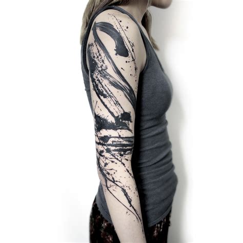 An Abstract Tattoo Design With Black And White Lines On The Upper Half Of The Body