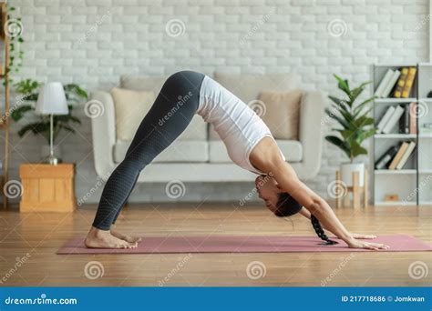 Calm Of Beautiful Attractive Asian Woman Practice Yoga Downward Facing