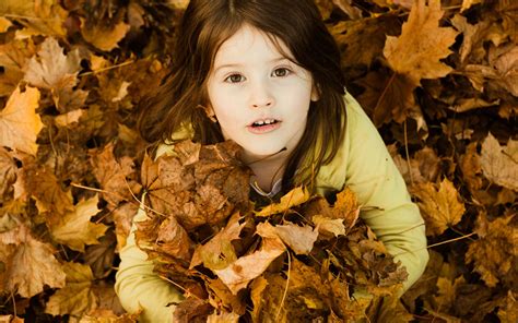 Child With Autumn Leaves Cute Girl In Beautiful Autumn Leaves On The