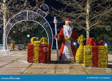 Decorative Santa Claus With Gifts Made Of Christmas Tinsel Background