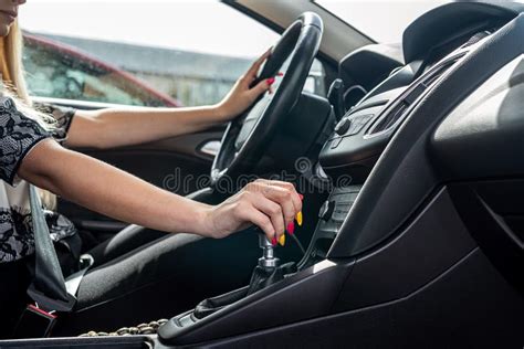 Female Driver Hand Shifting Gear Shift Knob Manually Before The Beginning Of Ride Stock Photo