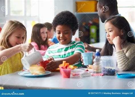 Group Of Children Eating Lunch In School Cafeteria Stock Image Image