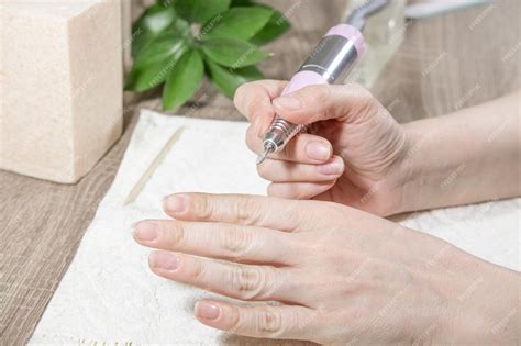 Manicurist Woman Processes Nails And Cuticles Or Removes Nail Polish