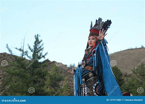 Mongolian Woman In Shaman And Witch Costume Dances On Stage In The