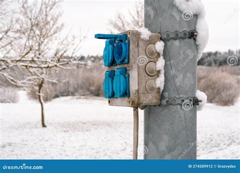 Outdoor Power Plug Socket Box With Cover On The Steel Pole Stock Photo