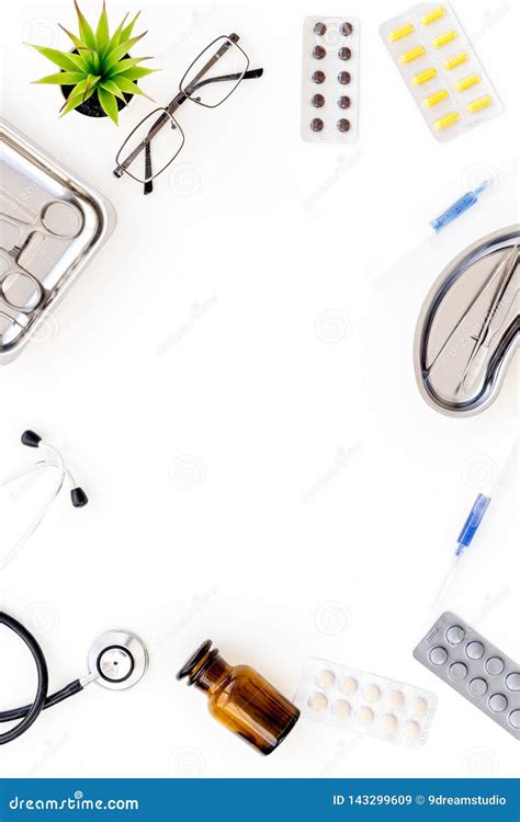 Pills And Instruments Of Doctor Frame On White Background Top View Copyspace Stock Photo Image