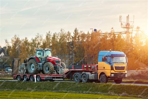 Premium Photo The Semi Truck Is Hauling Farm Equipment On A Flatbed