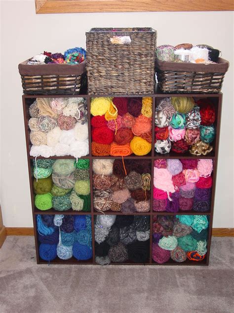 Several Clear Drawers With Yarn In Them On The Floor Next To A White