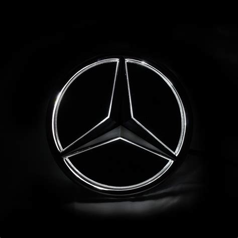 The Front Emblem Of A Car On A Black Background