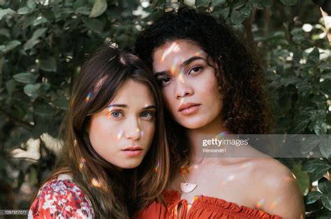 Two Beautiful Women Embracing In Nature Stock Photo