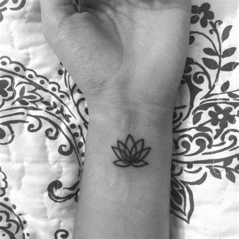 Wrist Tattoo Of A Minimalist Lotus Flower On Miranda